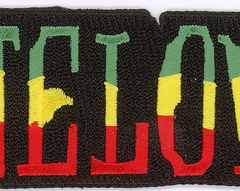 May include: A black fabric patch with the word "ONE LOVE" embroidered in red, yellow, and green thread.