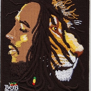 May include: Embroidered patch featuring a profile of Bob Marley with dreadlocks, a tiger face overlapping his hair, and the text "BOB MARLEY" at the bottom.