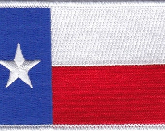 May include: Embroidered patch featuring the flag of Texas. The design includes a blue vertical stripe with a white star, a white horizontal stripe, and a red horizontal stripe. The patch has a white border.