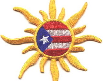 May include: Embroidered patch featuring the flag of Puerto Rico within a yellow sunburst design. The circular center displays the flag's blue triangle with a white star, and red and white stripes. The sun's rays are a bright yellow.