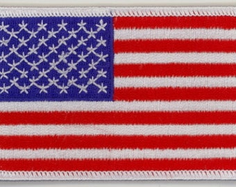 May include: Embroidered patch featuring the American flag. The patch has a blue rectangle in the upper left corner with white embroidered stars. The rest of the patch has red and white stripes. The patch is rectangular with a white border.
