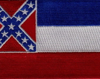 May include: A red, white, and blue flag with a blue canton and a white star-filled cross on a red field. The flag is made of fabric and has a textured surface.