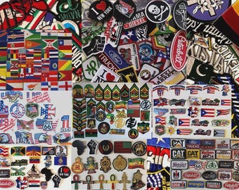 May include: A collection of embroidered patches with various designs, including flags, military insignia, and logos. The patches feature a variety of colors and shapes, with text such as "USA", "New York", and "Ford".