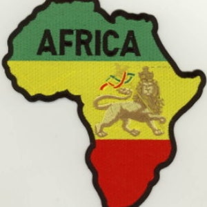 May include: An embroidered patch shaped like the continent of Africa. The patch is green, yellow, and red, with a lion in the centre. The word "AFRICA" is embroidered in black letters across the top of the patch.