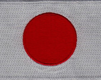 May include: A white fabric patch with a large red circle in the center. The circle is a representation of the Japanese flag.