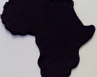 May include: Black fabric outline of the continent of Africa.