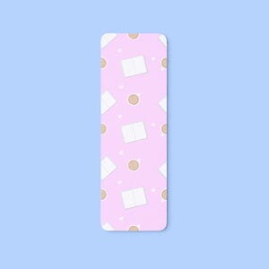 May include: A rectangular bookmark with a pink background featuring a repeating pattern of white open books, brown coffee cups, and small white hearts. The bookmark is a reading accessory.