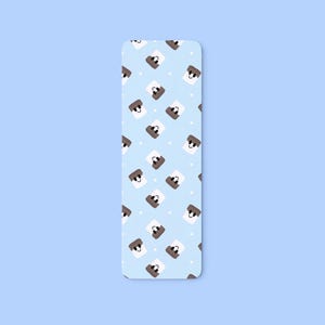 May include: A rectangular bookmark with rounded corners, featuring a light blue background adorned with a repeating pattern of cartoon marshmallows. Each marshmallow has a brown face and is set against a white background with small white dots.