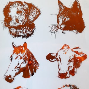 May include: A sheet of six copper-colored animal silhouettes. The animals are a dog, cat, horse, cow, goat, and sheep. The silhouettes are cut out of the sheet and are ready to be applied to a surface.