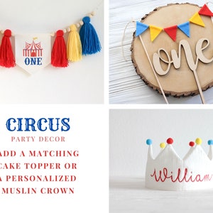 May include: A circus-themed party decoration set with a banner that says "ONE" and a red, yellow, and blue tassel garland. The set also includes a wooden cake topper with the word "one" and a white muslin crown with the name "William" written in red.