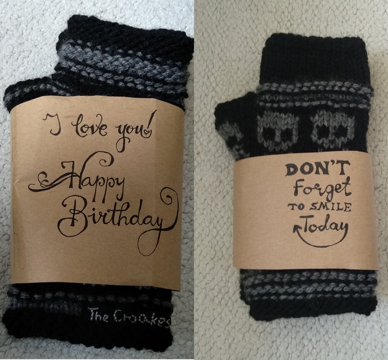 May include: A pair of black and gray knit socks wrapped in brown paper with a handwritten message that says "I love you! Happy Birthday" and "The Crookes". The other sock is wrapped in brown paper with a handwritten message that says "DON'T forget to smile Today".