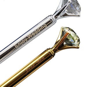 May include: Two diamond ring pens, one silver with the inscription "Enjoy Wedding" and one gold with the inscription "Jane Ren".