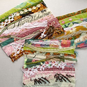 May include: A multi-layered fabric scrap quilt featuring a range of textures and colours, including green, brown, pink, white, and red. The quilt is crafted from various fabrics, such as lace, gingham, and floral prints. The quilt is stitched together using a variety of stitches, including a running stitch and a backstitch. The quilt is a unique and handmade piece of art.