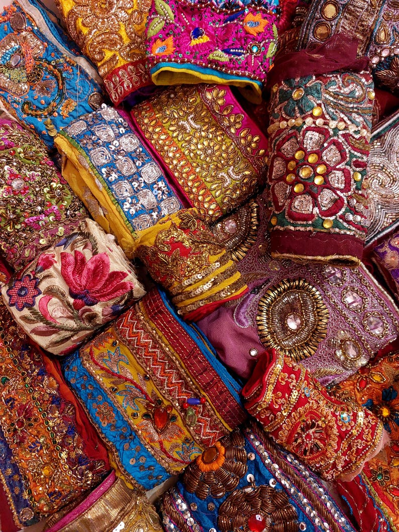 Discover a stunning assortment of vintage Indian saree trims with this wholesale lot! Each piece features rich embroidery, sequins, beads, and zari work, making it perfect for DIY projects, fashion, and home décor.
Each bag includes a minimum of 10, 15, or 25 beautifully embroidered fabric pieces, perfect for embellishments, crafts, collage, ribbons, and border trims.
This one-of-a-kind mix of handcrafted trims is perfect for crafters, designers, and creative minds.