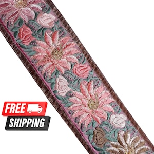 May include: Pink and brown floral embroidered trim with a brown velvet border. The trim features a repeating pattern of pink and white flowers with green leaves.