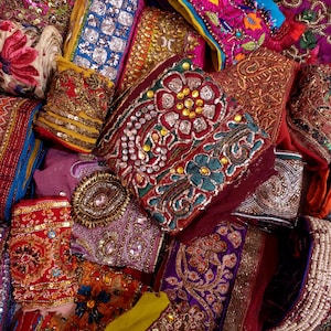 Discover a stunning assortment of vintage Indian saree trims with this wholesale lot! Each piece features rich embroidery, sequins, beads, and zari work, making it perfect for DIY projects, fashion, and home décor.
Each bag includes a minimum of 10, 15, or 25 beautifully embroidered fabric pieces, perfect for embellishments, crafts, collage, ribbons, and border trims.
This one-of-a-kind mix of handcrafted trims is perfect for crafters, designers, and creative minds.