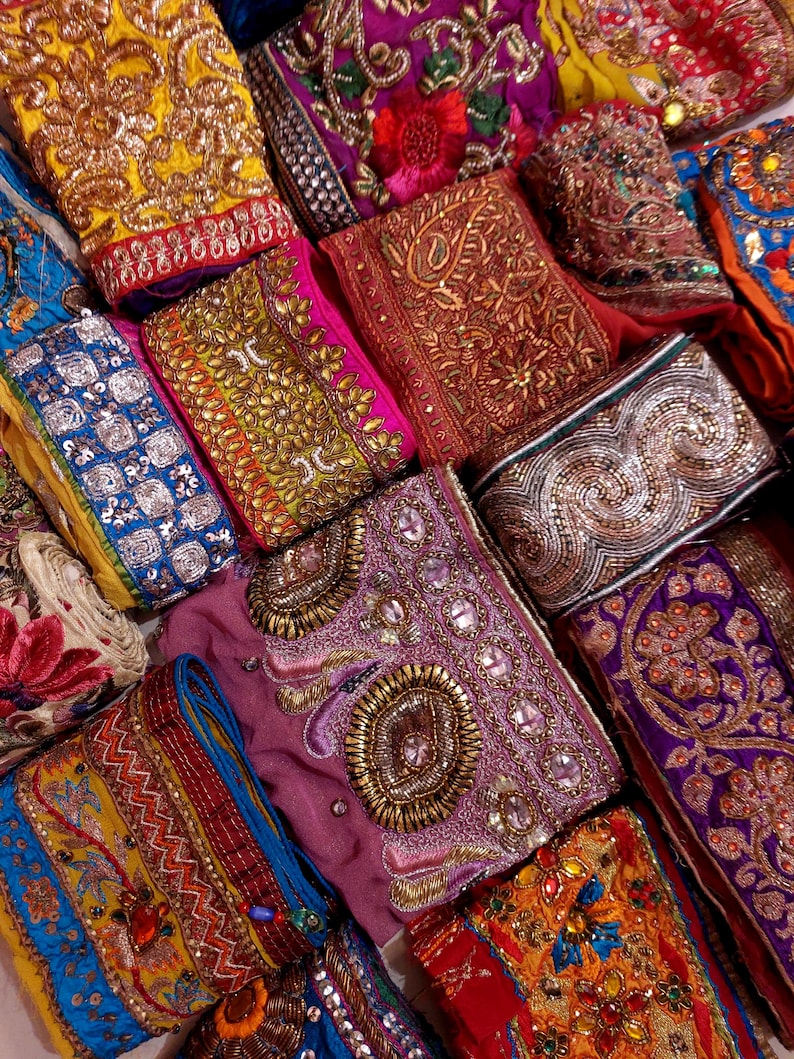 Discover a stunning assortment of vintage Indian saree trims with this wholesale lot! Each piece features rich embroidery, sequins, beads, and zari work, making it perfect for DIY projects, fashion, and home décor.
Each bag includes a minimum of 10, 15, or 25 beautifully embroidered fabric pieces, perfect for embellishments, crafts, collage, ribbons, and border trims.
This one-of-a-kind mix of handcrafted trims is perfect for crafters, designers, and creative minds.