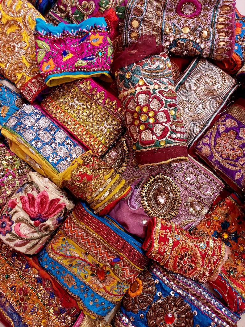 Discover a stunning assortment of vintage Indian saree trims with this wholesale lot! Each piece features rich embroidery, sequins, beads, and zari work, making it perfect for DIY projects, fashion, and home décor.
Each bag includes a minimum of 10, 15, or 25 beautifully embroidered fabric pieces, perfect for embellishments, crafts, collage, ribbons, and border trims.
This one-of-a-kind mix of handcrafted trims is perfect for crafters, designers, and creative minds.