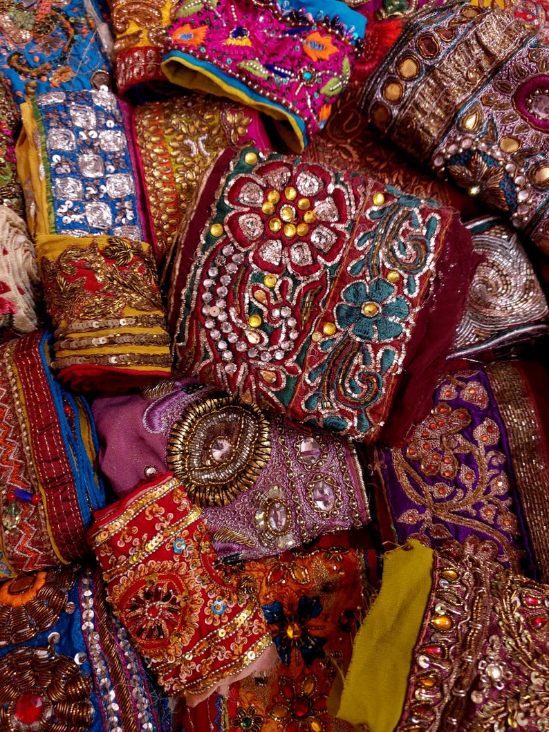 Discover a stunning assortment of vintage Indian saree trims with this wholesale lot! Each piece features rich embroidery, sequins, beads, and zari work, making it perfect for DIY projects, fashion, and home décor.
Each bag includes a minimum of 10, 15, or 25 beautifully embroidered fabric pieces, perfect for embellishments, crafts, collage, ribbons, and border trims.
This one-of-a-kind mix of handcrafted trims is perfect for crafters, designers, and creative minds.