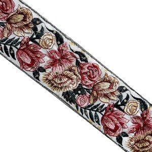 May include: White fabric trim with embroidered floral design in shades of pink, yellow, and green. The trim features sequins and a black outline.