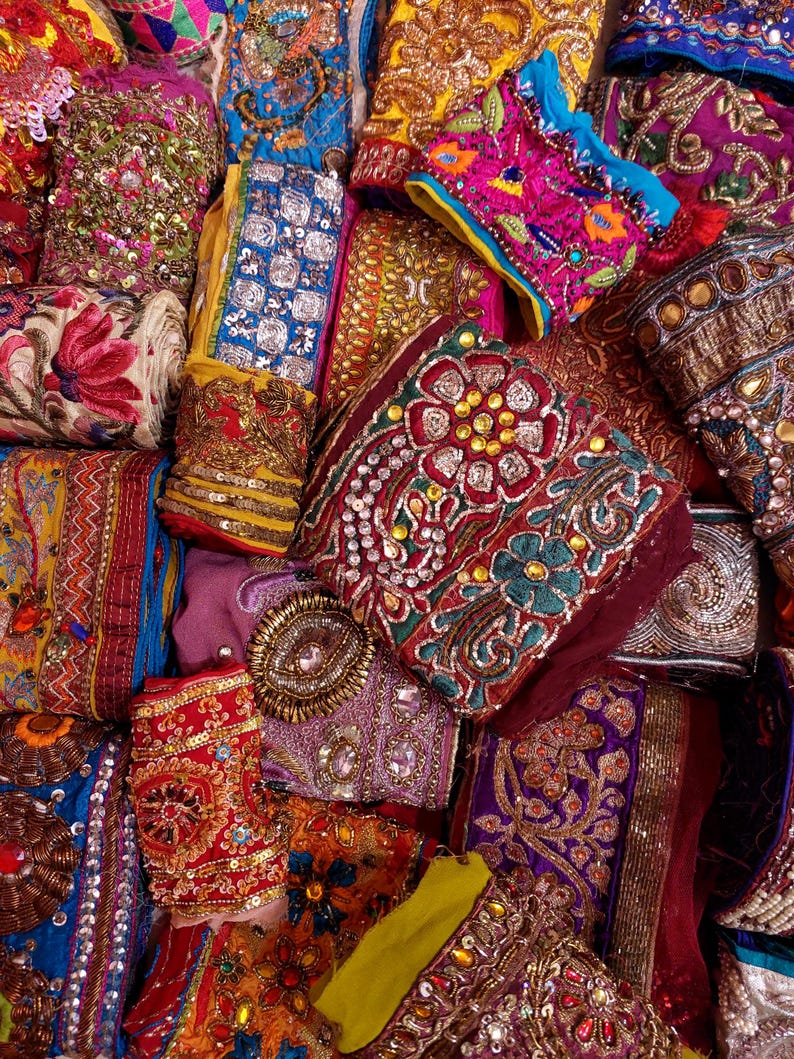 Discover a stunning assortment of vintage Indian saree trims with this wholesale lot! Each piece features rich embroidery, sequins, beads, and zari work, making it perfect for DIY projects, fashion, and home décor.
Each bag includes a minimum of 10, 15, or 25 beautifully embroidered fabric pieces, perfect for embellishments, crafts, collage, ribbons, and border trims.
This one-of-a-kind mix of handcrafted trims is perfect for crafters, designers, and creative minds.