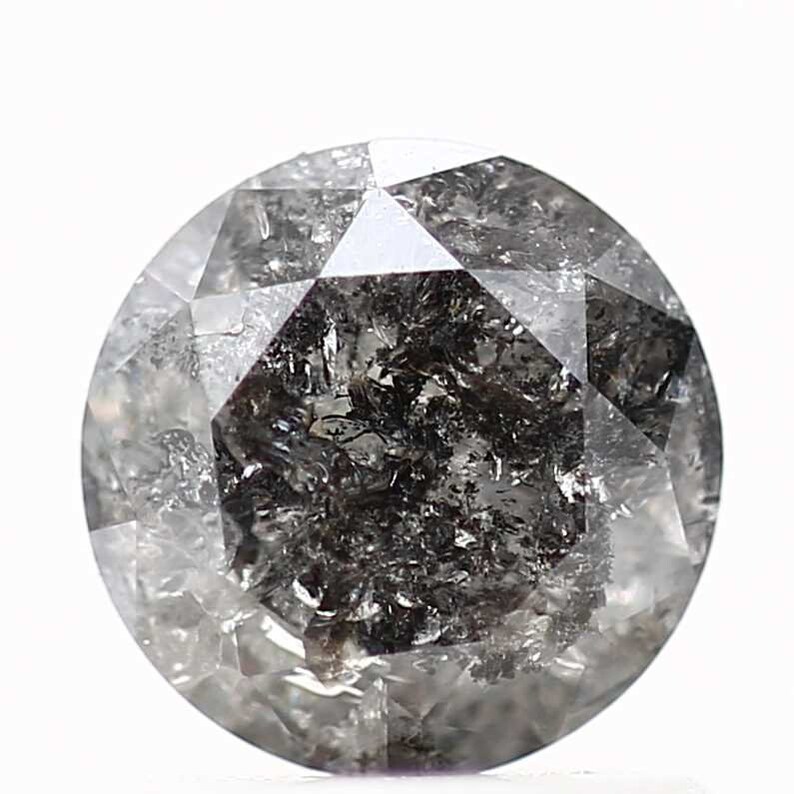 May include: A round, faceted, black diamond with inclusions. The diamond is clear with a dark gray color.