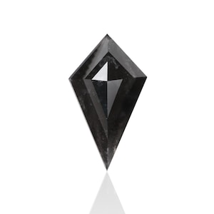 May include: A black diamond shaped like a kite with a pointed tip. The diamond has a dark gray color and is faceted.