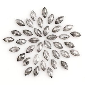 May include: A collection of 30 gray marquise-shaped diamonds arranged in a circular pattern on a white background.