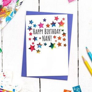 May include: A white card with a purple envelope. The card has a colorful star design and the text "Happy Birthday Nan!"
