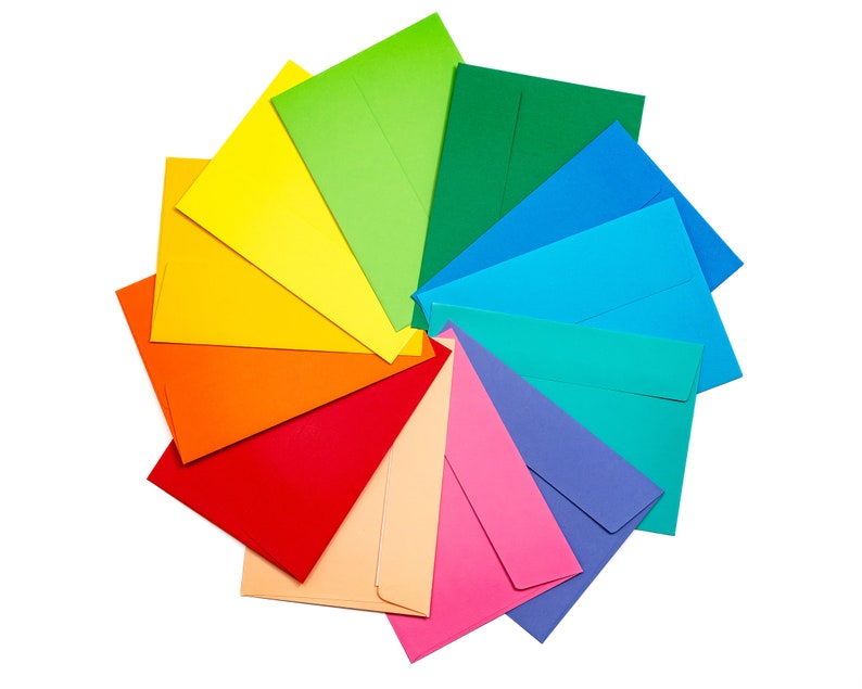 May include: A rainbow of colorful envelopes arranged in a circle, with the colors transitioning from red to orange, yellow, green, blue, and purple.