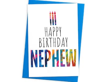 May include: A white greeting card with a blue envelope featuring three colorful painted candles at the top. Below the candles, the text reads HAPPY BIRTHDAY in black, followed by the word NEPHEW in large, multicolored, textured block letters.