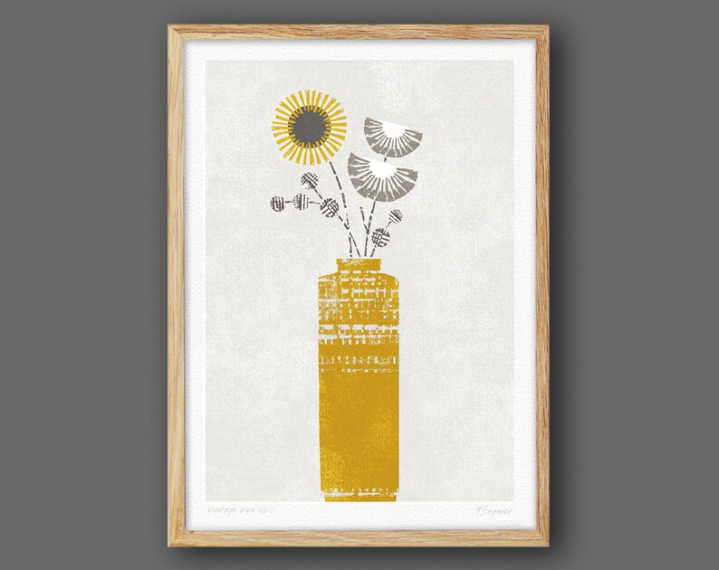 May include: A framed print of a stylized illustration of a yellow vase with a gray and white floral arrangement. The vase has a textured pattern and the flowers are stylized with geometric shapes.