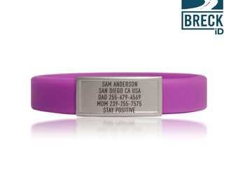 May include: Purple silicone bracelet with a silver metal tag engraved with the text "SAM ANDERSON SAN DIEGO CA USA DAD 255-479-4569 MOM 239-255-7575 STAY POSITIVE".