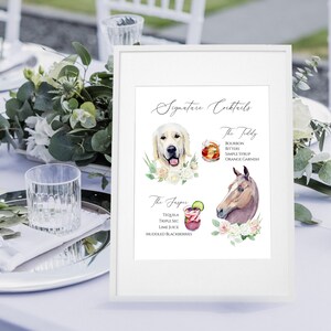 May include: A white framed sign with the title "Signature Cocktails" and two cocktail recipes. The first recipe is called "The Filly" and features a golden retriever illustration. The second recipe is called "The Frspr" and features a horse illustration.
