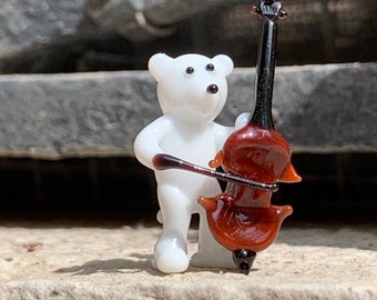 White or brown bear playing the bass, Murano glass double bassist lampworked in Venice. See all the orchestra players and musicians