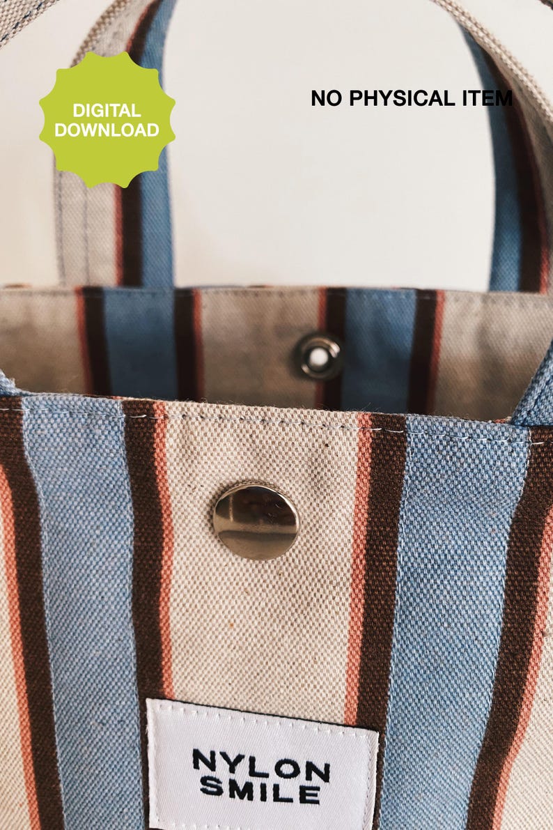 May include: A tote bag featuring vertical stripes in light blue, dark brown, and cream. The bag has a silver metal snap closure and a white rectangular label with the black text NYLON SMILE. A green starburst graphic reads DIGITAL DOWNLOAD and NO PHYSICAL ITEM.