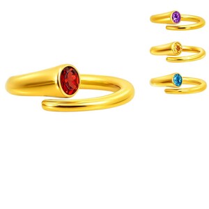 May include: Gold-colored rings with gemstone accents. The main ring features a red gemstone, while three smaller rings display purple, yellow, and blue gemstones. The rings have a unique, open design.