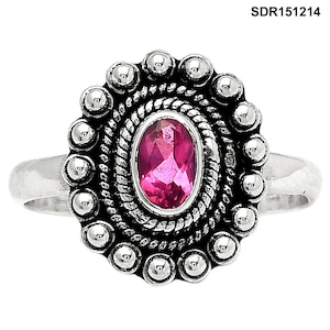 Puede incluir: Un anillo de plata con una piedra preciosa rosa de corte ovalado en el centro, rodeada por un borde de cuerda trenzada y un borde festoneado de pequeñas esferas de plata. El texto SDR151214 es visible en la esquina superior derecha.