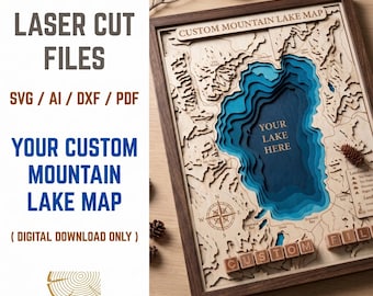 May include: A framed wooden laser-cut map of a lake with layered blue depths. The map includes the text "YOUR LAKE HERE" and "CUSTOM MOUNTAIN LAKE MAP". The frame is dark brown, and the map is on a light wood surface. The text "LASER CUT FILES" is also visible.