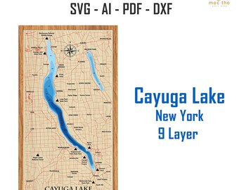 May include: A wooden laser-cut map of Cayuga Lake in New York, featuring a blue lake outline and surrounding towns. The map is framed in wood and includes the text "Cayuga Lake New York 9 Layer".
