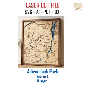 May include: A wooden laser-cut map of Adirondack Park, New York, with blue water features and a compass rose. The map is framed in a dark wood frame. Text at the top reads "LASER CUT FILE SVG - AI - PDF - DXF". The text "Adirondack Park New York 8 Layer" is at the bottom.