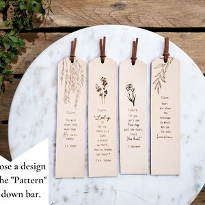 May include: Four wooden bookmarks with different designs and quotes. Each bookmark features a different floral design and a quote about hope and faith. The bookmarks are on a white marble surface.