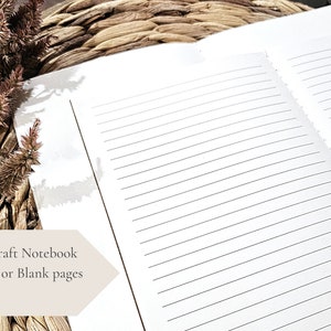 May include: A5 kraft notebook with lined pages. The notebook is open to show the lined paper. The notebook is on a woven surface.