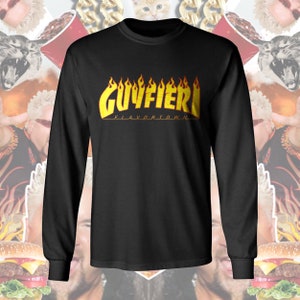 May include: Black long-sleeve t-shirt with a yellow and orange "Guy Fieri" logo with flames. The text "Flavortown" is below the logo.