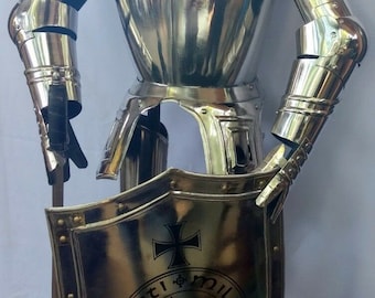 May include: A silver knight in full armor holding a sword and shield. The shield has a black and white crest with a cross and a horse. The knight is standing on a black wooden base.