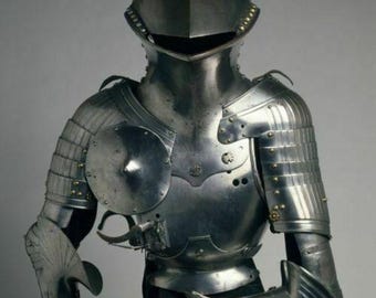 May include: A silver suit of armor with a helmet, breastplate, and gauntlets. The armor is detailed with rivets and decorative elements.