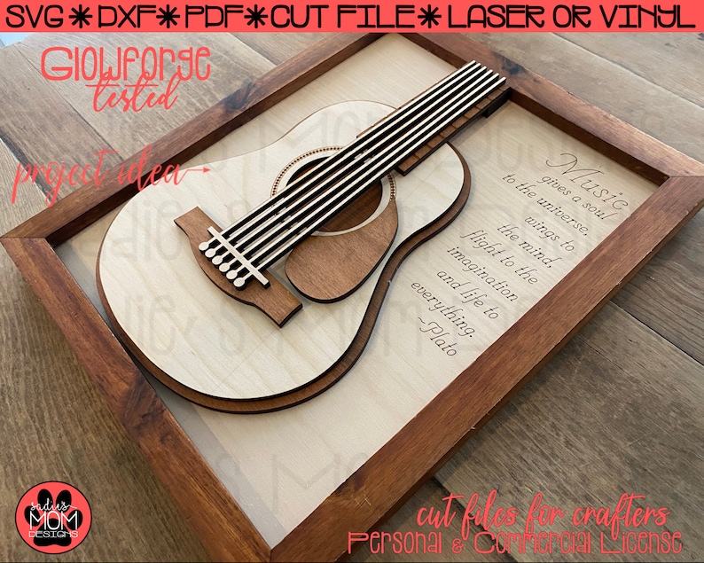 May include: A wooden framed wall art piece featuring a laser cut design of an acoustic guitar with the quote "Music gives a soul to the universe, wings to the mind, flight to the imagination and life to everything. -Plato"