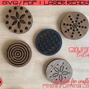 May include: Five wooden coasters with laser-cut designs, including floral and geometric patterns. One coaster is black, the others are brown. The image includes the text "SVG/PDF I LASER READY" and "Glowforge tested".