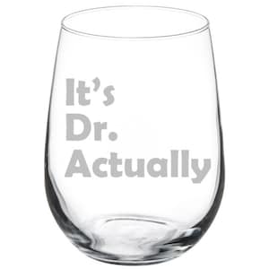 May include: A clear glass wine glass with the text "It's Dr. Actually" etched on the front.