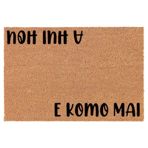 May include: A brown coir doormat with the text "A  huh  huh  E  k  o  m  o  m  a  i" in black lettering.